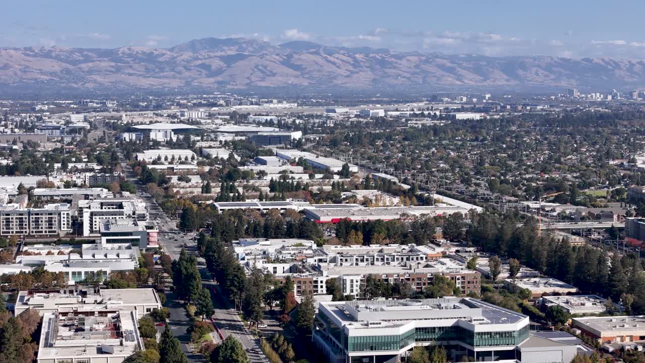Sweeping aerial view across Silicon Valley, showing Sunnyvale with the Diablo Range and downtown San Jose on the horizon