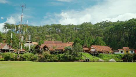 ancient architecture of cu lan ethnic village build in forest hill, da lat, vietnam - wide angle