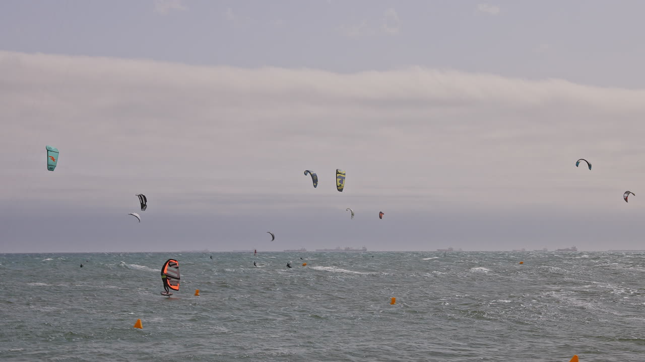 Kitesurfers on a windy day at sea in barcelona