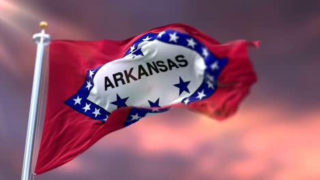 flag of arkansas state, region of the united states, waving at sunset - loop