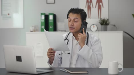 Indian-doctor-delivering-patient-news-on-phone