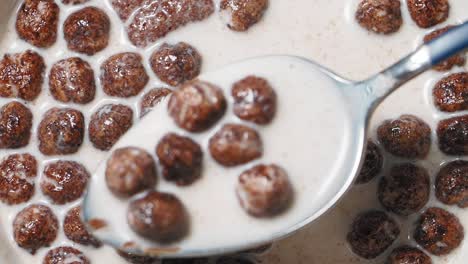 chocolate cereal in milk with a spoon