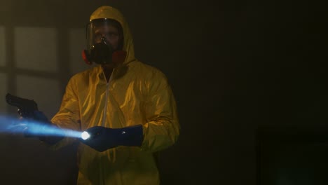 Hazmat-suit-wearing-man-explores-a-smoky-room