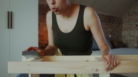 woman sanding a wooden table