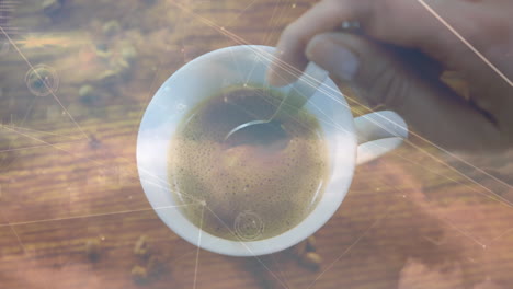 animation of hand stirring cup of coffee over network and data processing on moving clouds