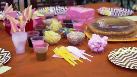 birthday party table setup with cake decorating supplies