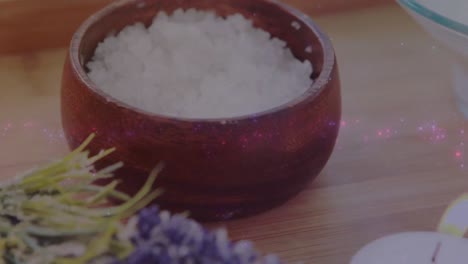 Animation-of-light-spots-over-spa-equipment,-candles-and-flower