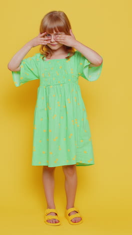 child girl kid closing eyes with hands spying through fingers hiding peeping seeking something