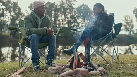 camping, fire and a couple talking in nature