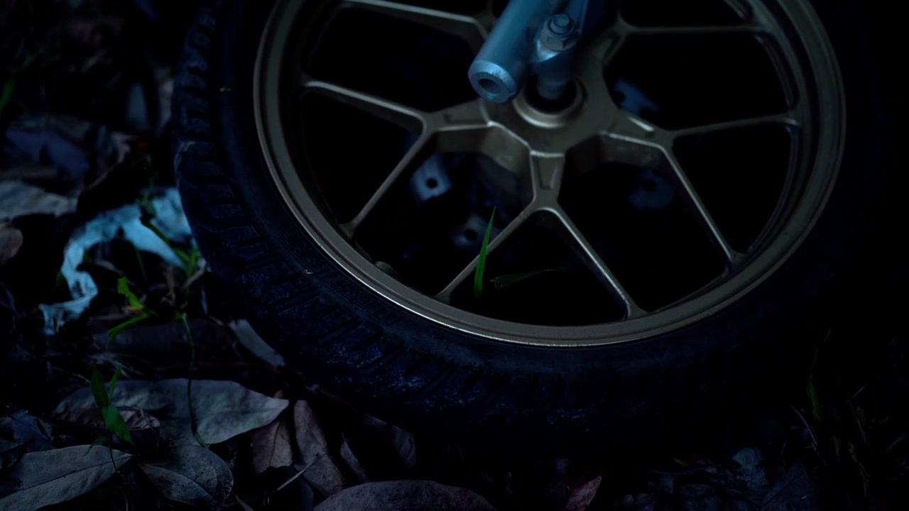 Motorcycle Wheel Illuminated by Flashing Red and Blue Emergency Lights