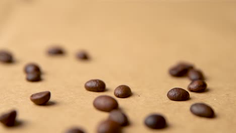 coffee beans falling from above on old paper slow motion