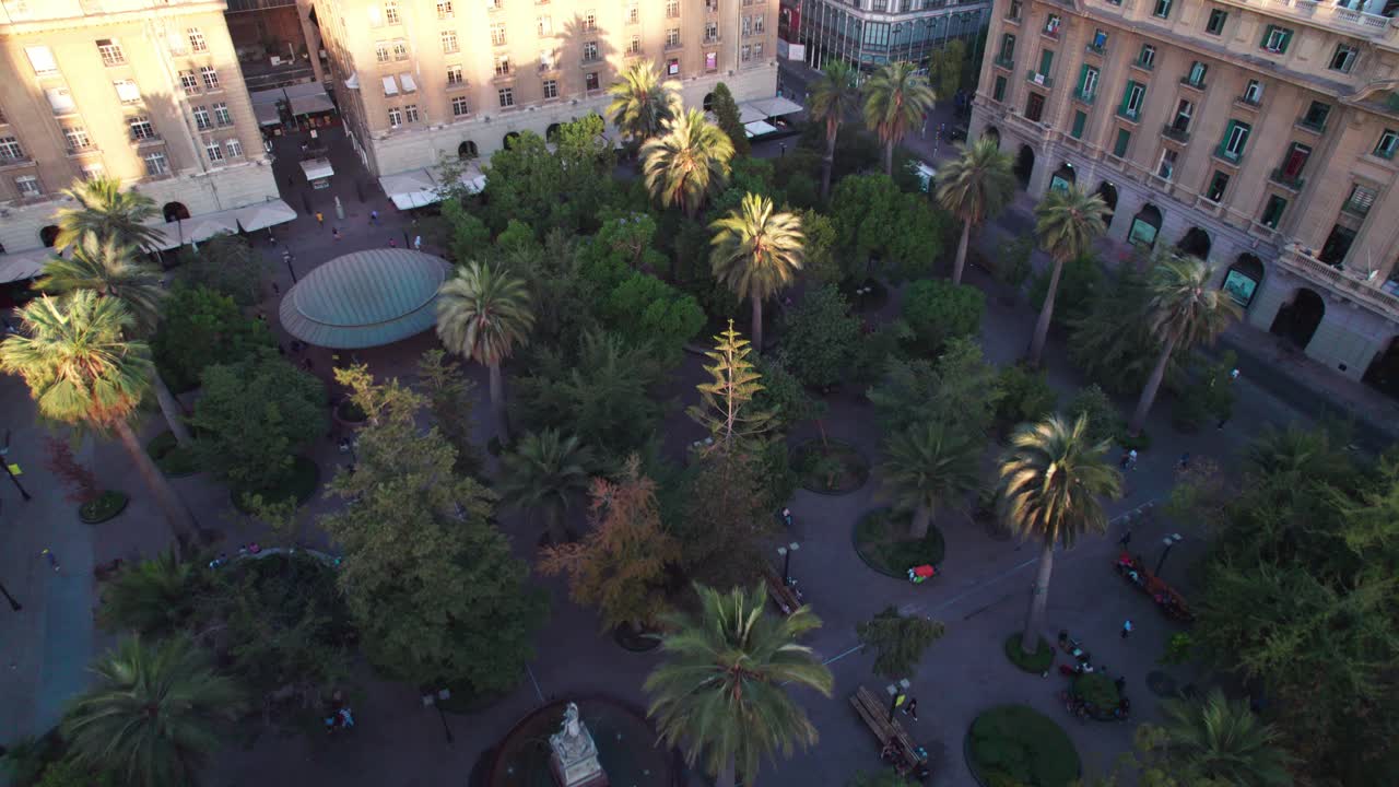Aerial view Plaza de Armas urban garden park square with sunlit palm trees in Santiago, Chile