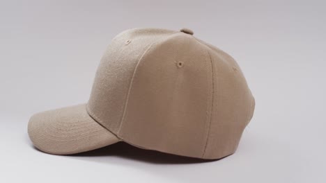 Video-of-beige-baseball-cap-and-copy-space-on-white-background
