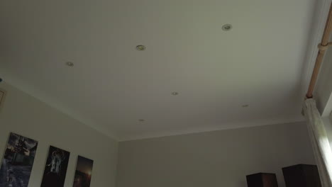 downward tilt shot of a modern looking bedroom in a family home in slow motion