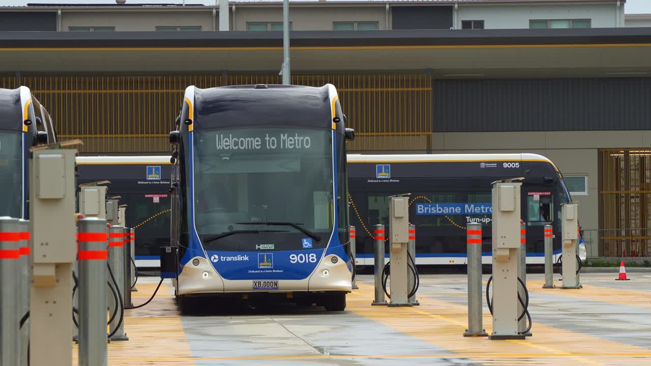 Bi-articulated Metro bus parked at the off-peak slow charging station in Rochedale depot, innovative bus rapid transit system in Queensland.