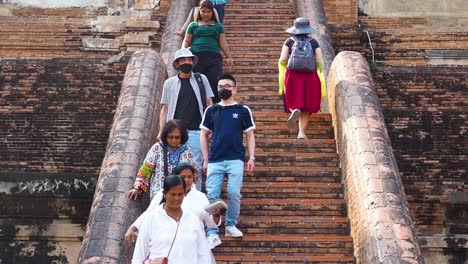 tourists explore historic temple steps in ayutthaya