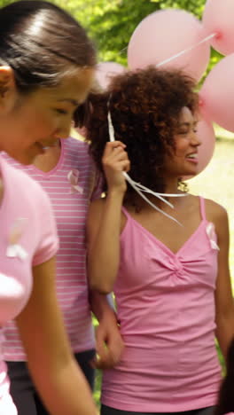 women going on a walk for breast cancer awareness in the park