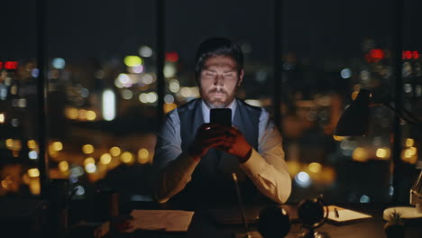 worker typing smartphone night office zoom on. serious boss messaging online