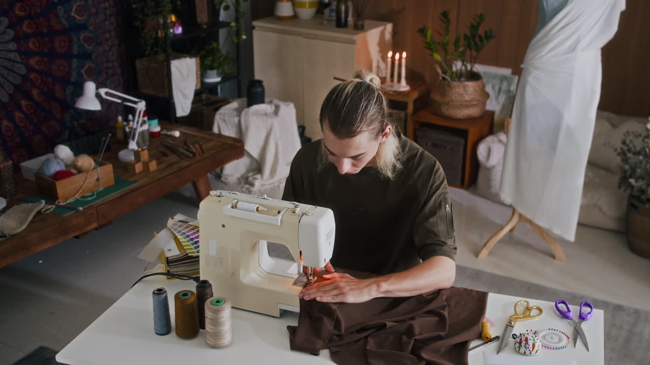 Tailor Sewing Dress for Client on Machine in Atelier