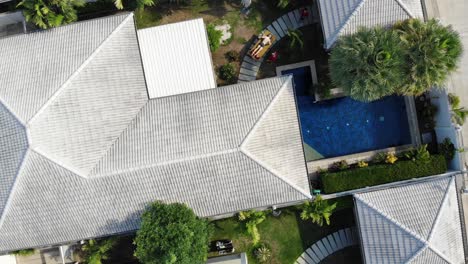 Birds-eye-drone-shot-of-man-getting-massage-near-swimming-pool