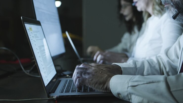 Cropped short of teleworkers using laptops