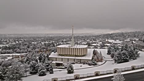 aerial orbit of southern side of provo lds mormon temple covered in snow on grey overcast day