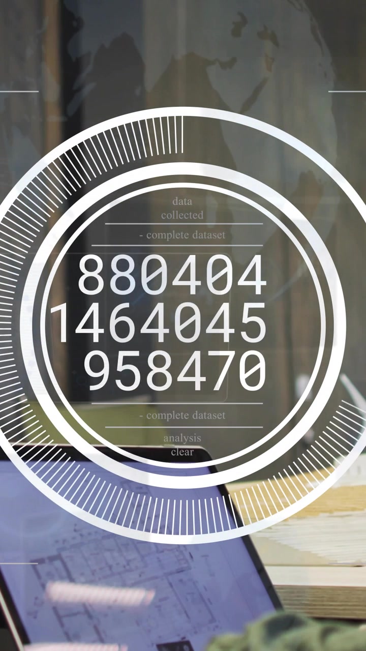 Vertical video: Desk worker reaching laptop, circular HUD appearing updating numbers for tech data