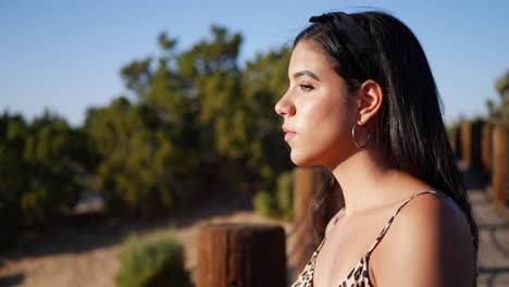 A-beautiful-hispanic-woman-traveler-watching-the-sunset-in-the-desert-with-gorgeous-eyes-SLOW-MOTION