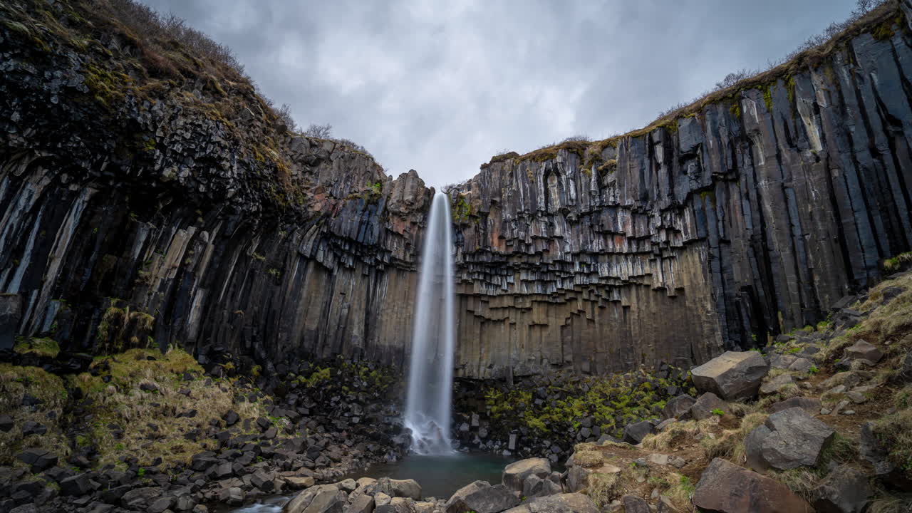 Timelapse of Svartifoss Waterfall, Iceland. Dramatic Stormy Sky Over Famous Fall