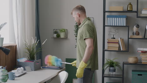 man cleaning a home office