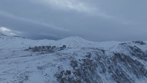 aerial establishing shot of the el colorado ski piste with a large resort below
