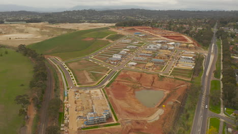 moving the camera gently forward from an aerial perspective, revealing a housing development in progress