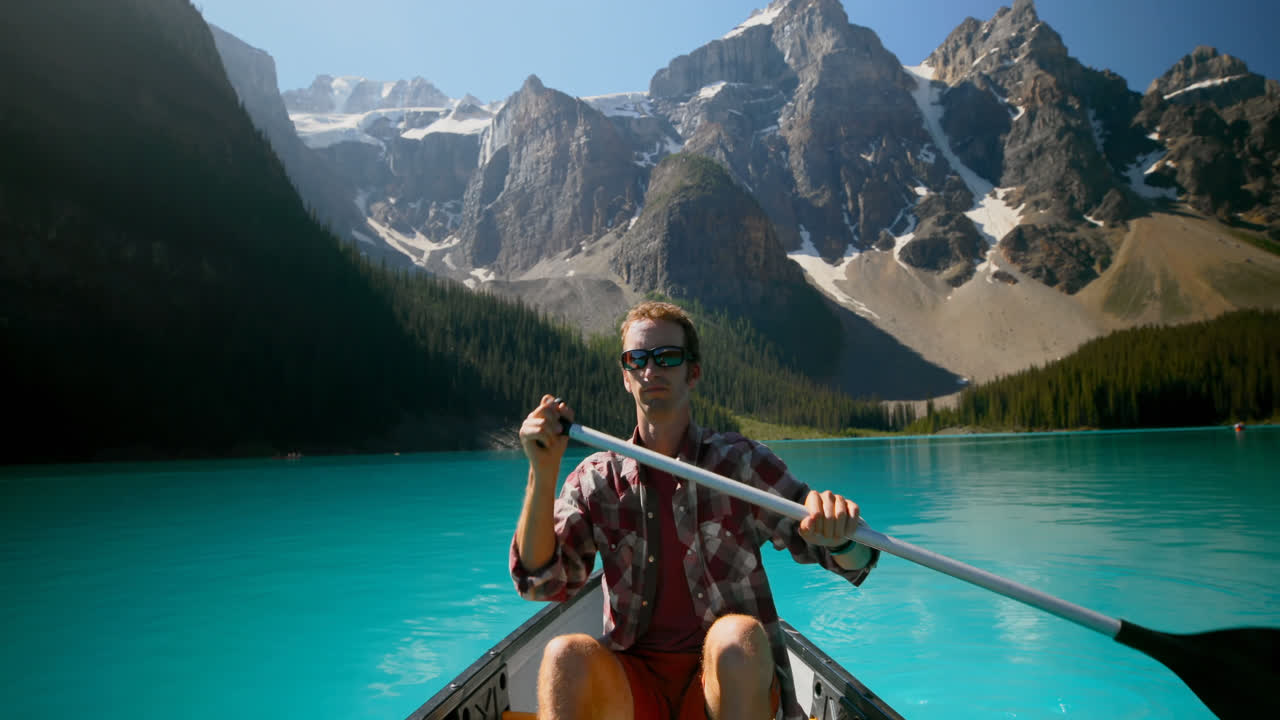 Man rowing a boat in river at countryside 4k