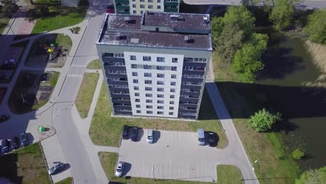 aerial birdseye view of crowded residential district apartment buildings on a sunny summer day, renovated and insulated houses, colorful walls of the facade, wide angle drone shot moving forward