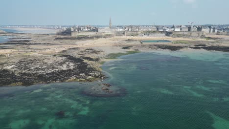 Low-angle-aerial-Saint-Malo-main-town-beach-France-drone-,-aerial-,-view-from-air