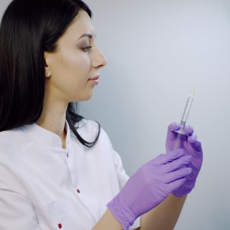 a cosmetologist prepares a syringe for beauty injections in the salon. botox. rejuvenation procedure