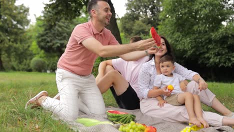 A Family on a Picnic in Nature they Eat a Ripe Red Watermelon they are Enjoying an Autumn Day a Family on a Picnic in Nature they Eat a Ripe Red Watermelon they are Enjoying an Autumn Day in Nature