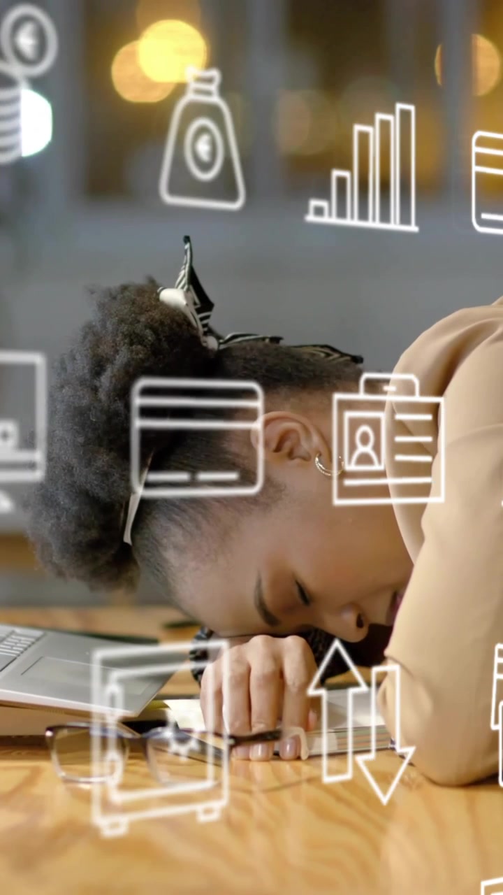 Animation of business icons over tired african american businesswoman waking up at office desk