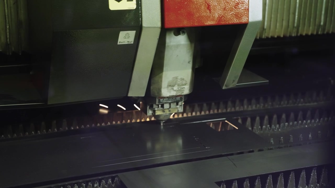 Automated industrial laser cutter precision cutting piece of metal