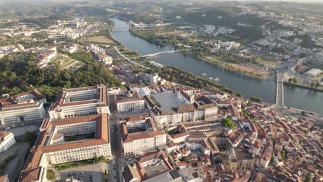 aerial orbiting over university buildings, coimbra town near mondego river