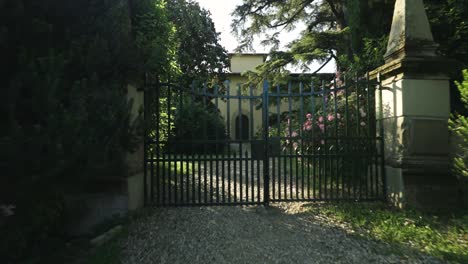 backwards revealing of the entrance of a villa with a beautiful garden