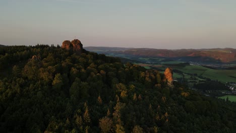 Drone-shot-wooded-mountain-and-rocky-mountains-in-a-pine-forest