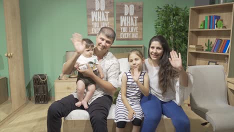 Happy-family-waving-at-home.