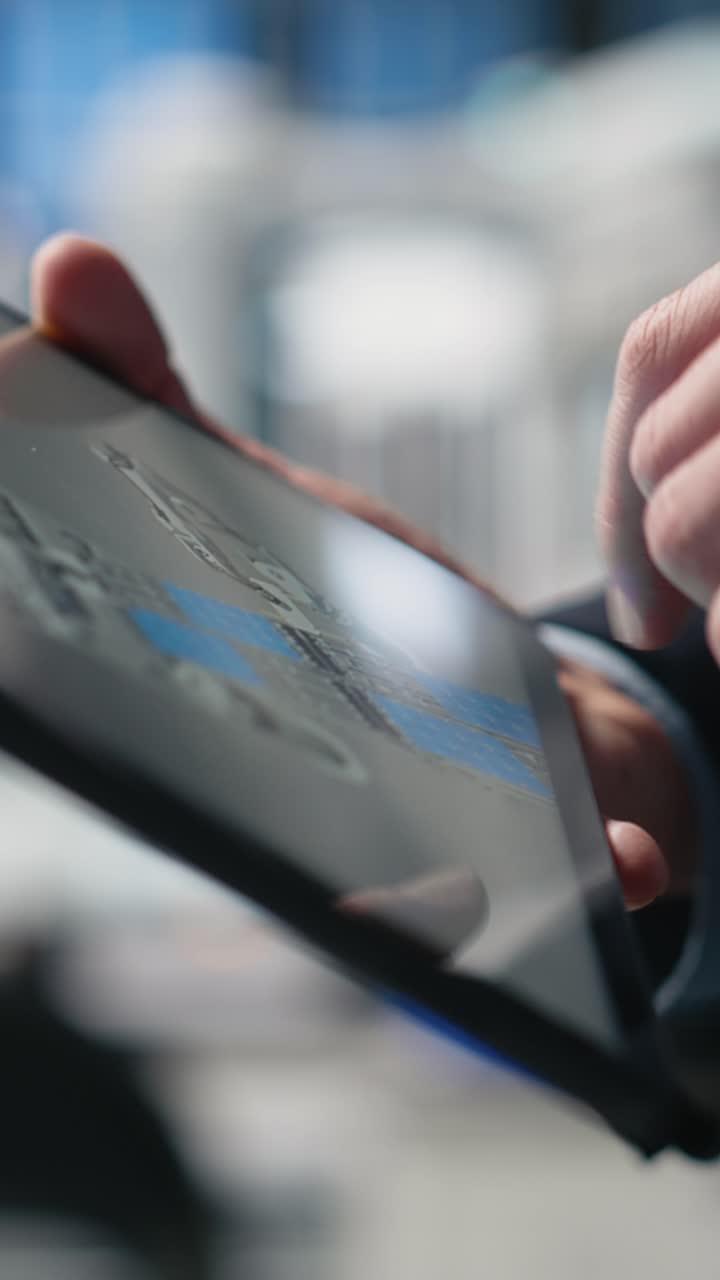 Vertical Video Quality control engineer in solar power factory evaluating industrial operations