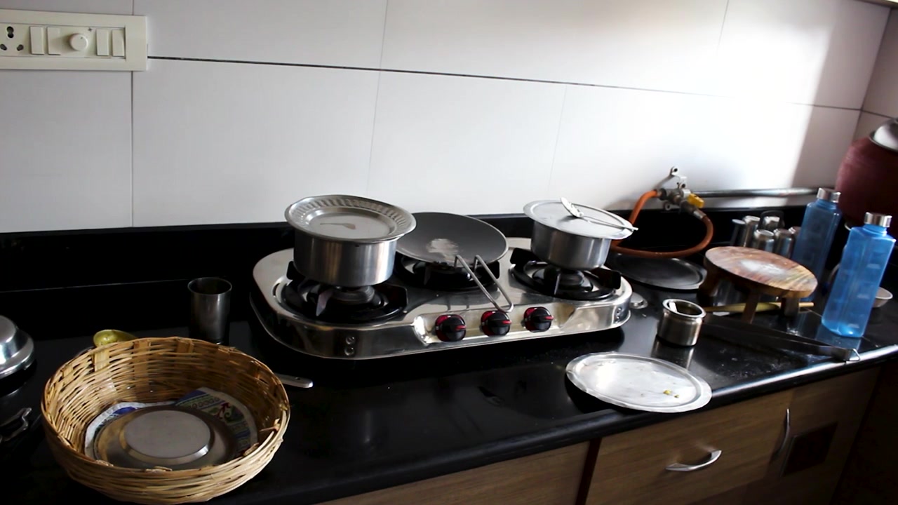 Clean Indian kitchen setup with cookware on a gas stove before cooking. Ideal for home cooking, food preparation, household routine, lifestyle, and culinary content.