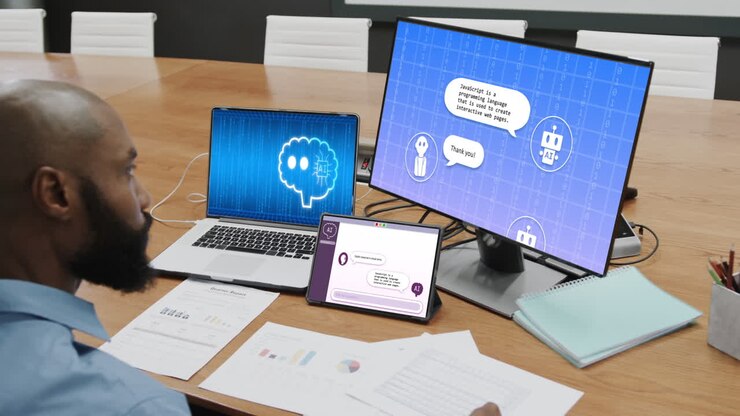 African american businessman using technology with digital chat on screens in office