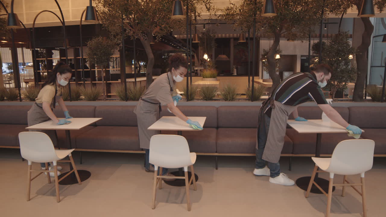 Restaurant Workers Wiping Tables Synchronously