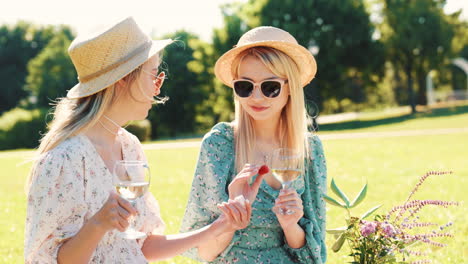 two women enjoying a picnic in a park