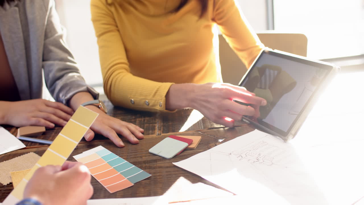 Interior design ideas, multiracial team using tablet and color swatches at table, at office
