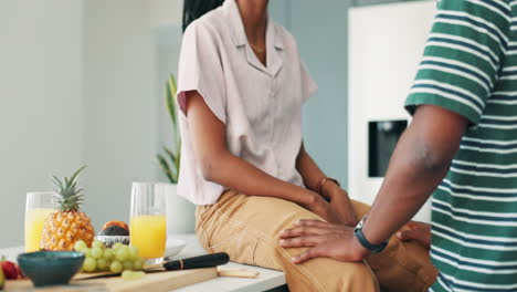 couple kissing in kitchen during breakfast